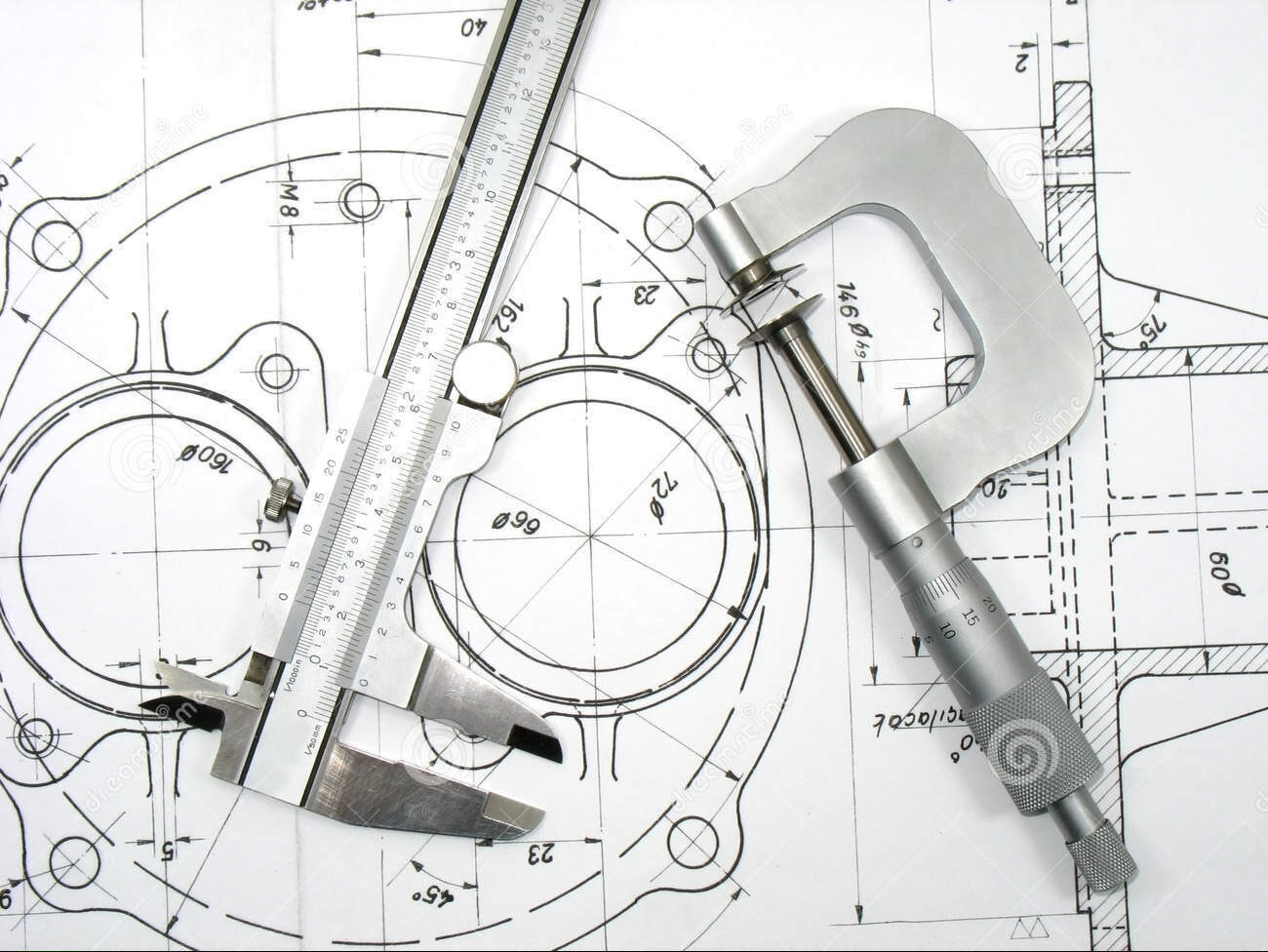 Caliper and micrometer resting on a dimensioned technical drawing